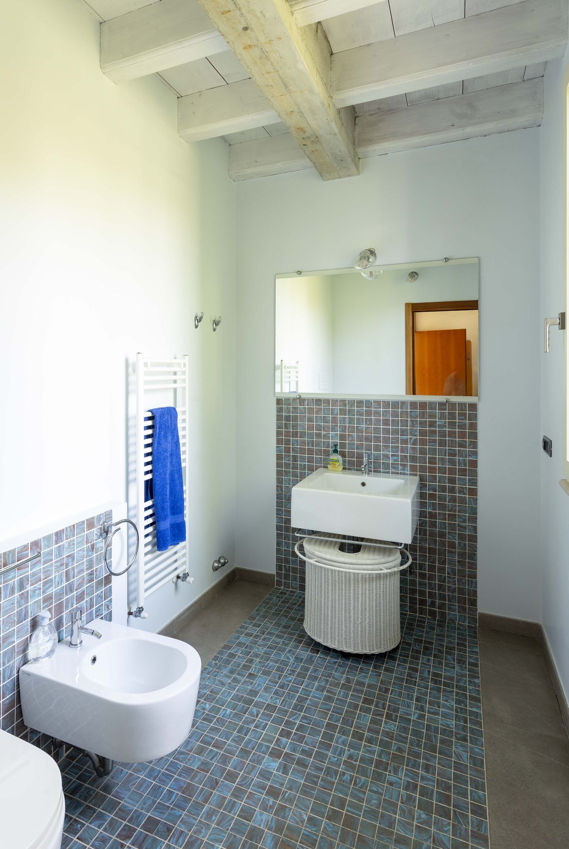 The bathroom off the living area, under whitewashed beams