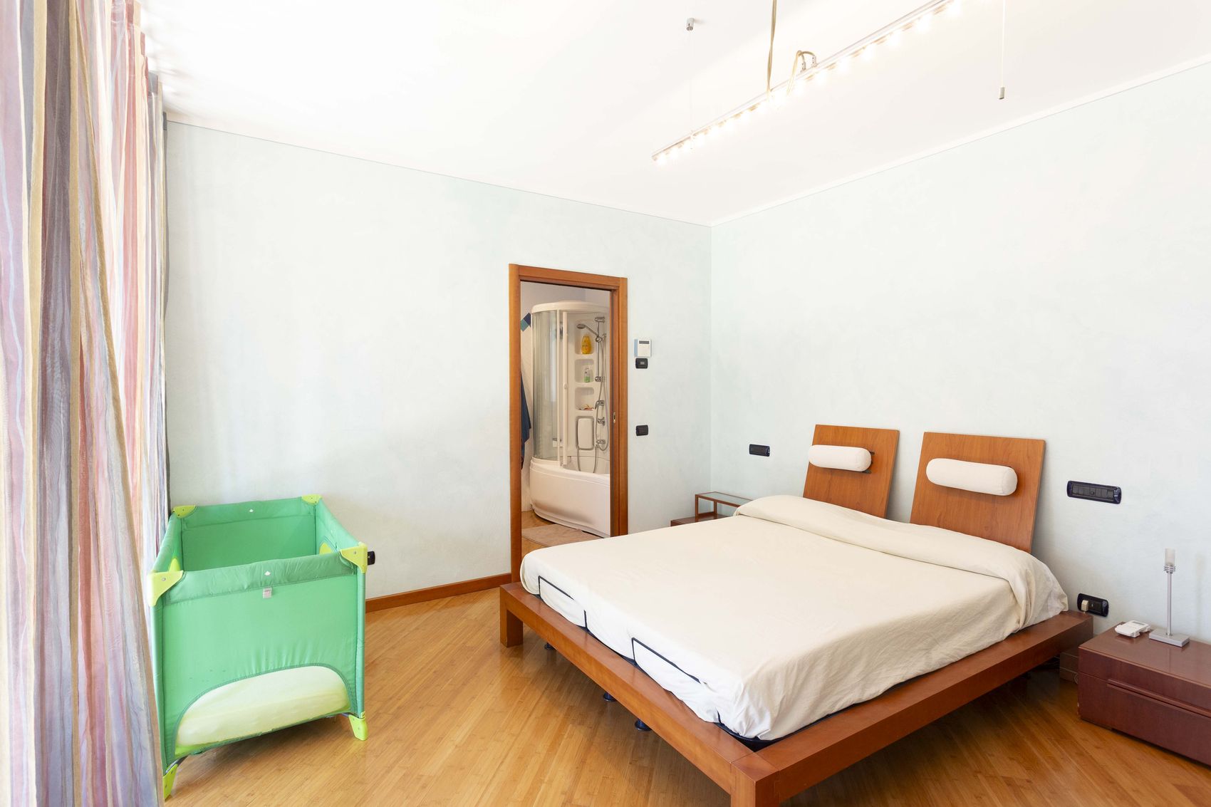 The master bedroom from the other end, with a travel cot set up