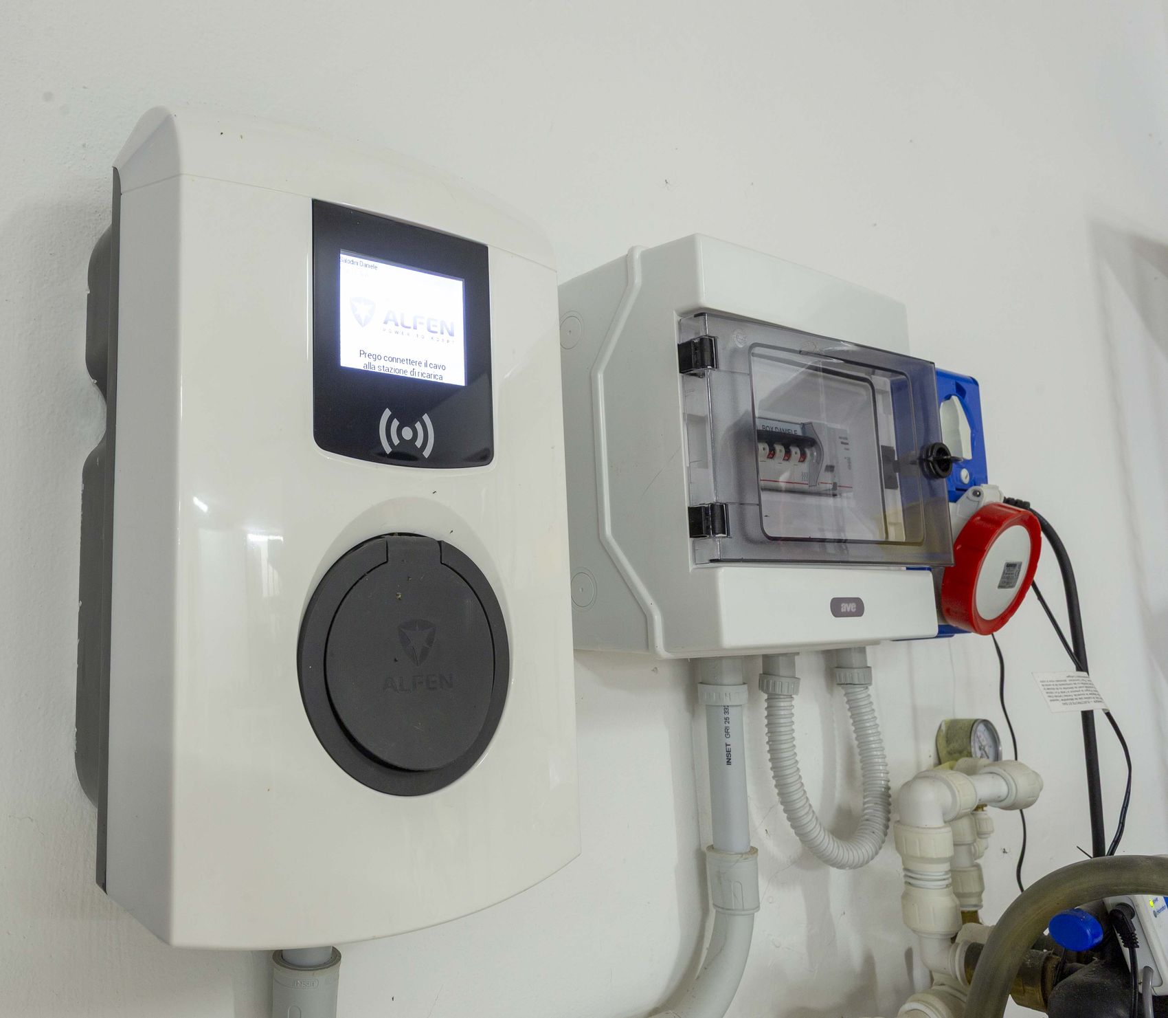The wall-mounted electric vehicle charge point in the garage