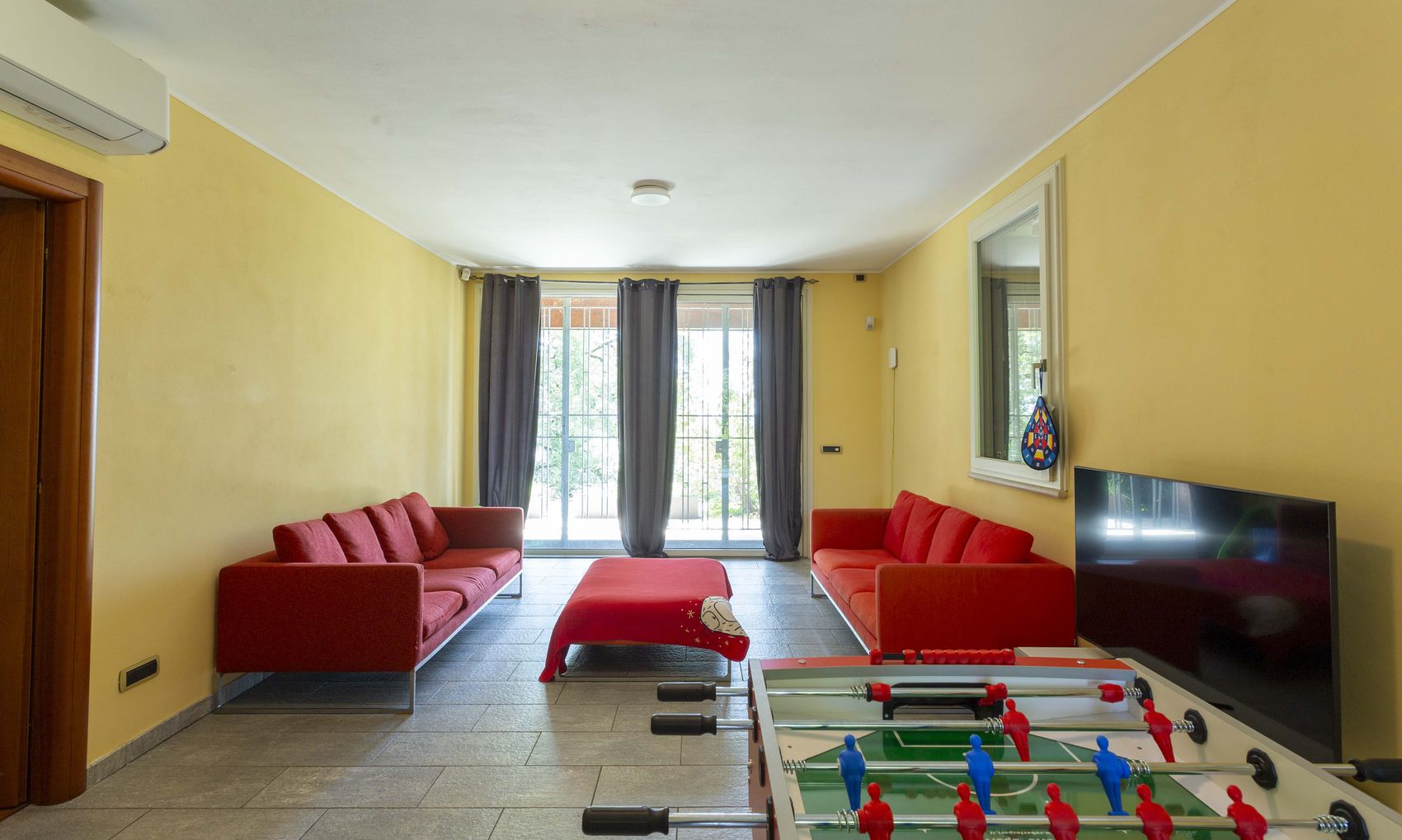 The games room with table football, television and sofas