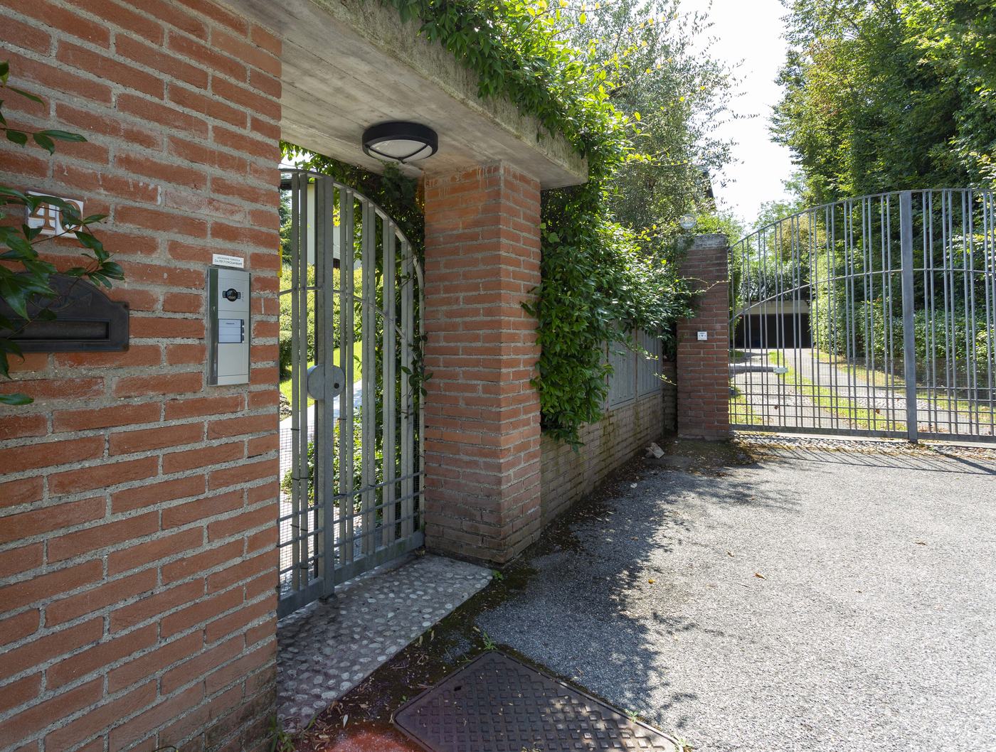 The intercom and postbox beside the pedestrian gate