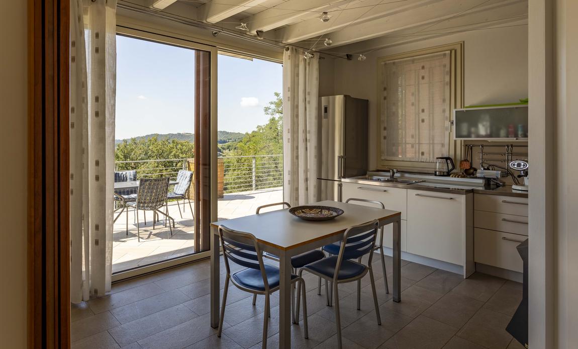 The kitchen opening onto the terrace dining table