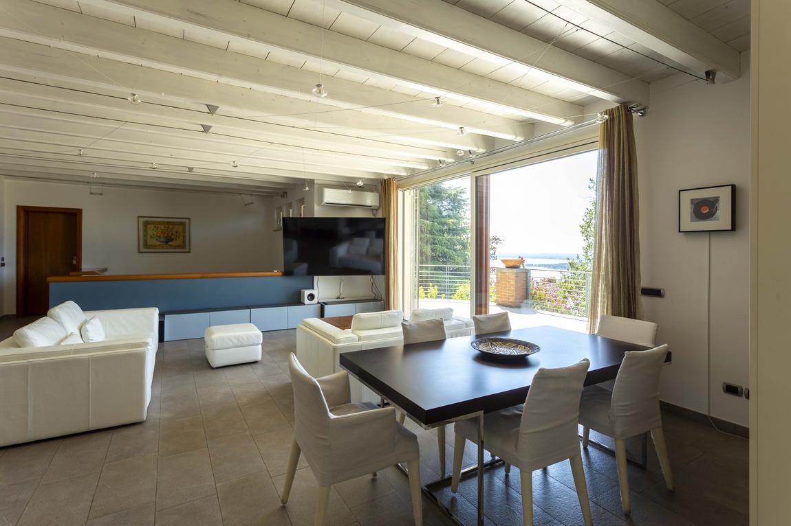 The dining table and sofas, with the lake through the window
