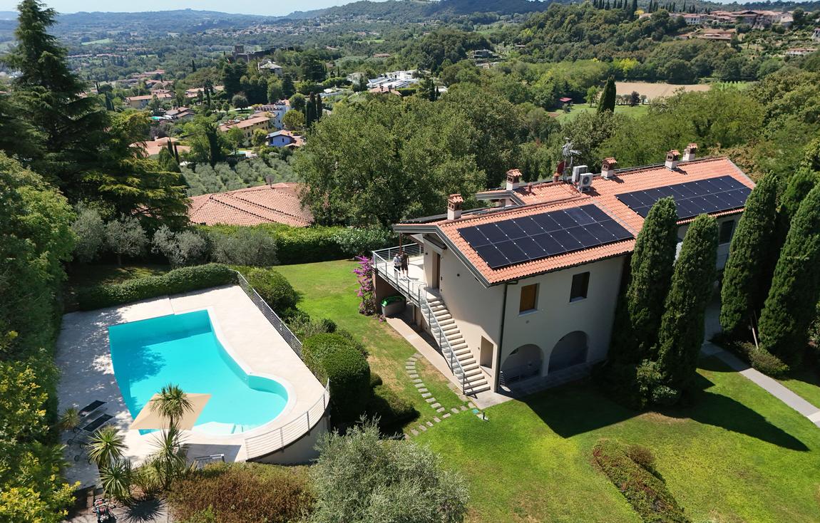 The pool terrace and the house from the hillside