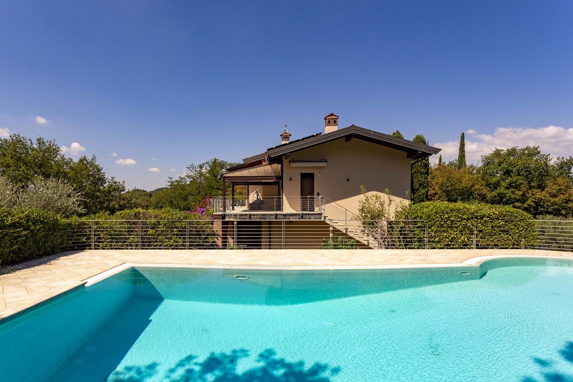 The house seen across the pool from the far side